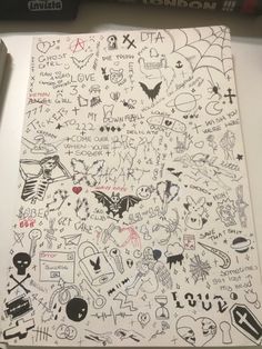 a large sheet of paper covered in lots of writing and doodled images on it