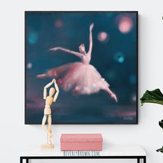 A dreamy ballerina jetées across a the stage. Painted in luminous shades of pink and coral against a backdrop of rich dark peacock blue, indigo and turquoise. The effect is both ethereal and dramatic. This sophisticated ballerina painting would be equally at home in a girls room or the space of a grown up ballet aficionado. The perfect gift for ballet lovers, ballet dancers, adult ballet students and teachers. Dark Peacock Blue