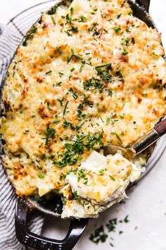 a casserole dish with cheese and herbs