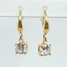 These elegant Gold Square Diamond Charm Earrings will instantly elevate your style. Crafted with a CZ dangle on gold hook, these earrings will add a touch of flair to any look. Perfect for a night out or a special occasion. Dress Purse, Square Diamond, Diamond Charm, Top Graphic Tees, Dress Jewelry, Rompers Women, Charm Earrings, Hats For Women, Night Out