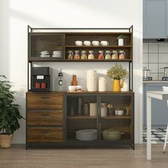 a kitchen with an open shelf next to a dining room table