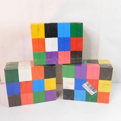 three blocks are stacked on top of each other in different colors and shapes, with a price tag attached