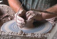 a man is making something out of clay