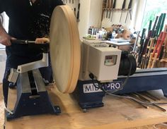 a man working on a machine in a shop