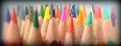 many colored pencils are lined up together