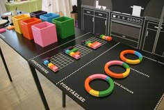 a table with some colorful objects on it and an oven in the backround