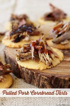 pulled pork cornbread tarts on top of a wooden board with text overlay that reads pulled pork cornbread tarts