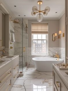 an elegant bathroom with marble floors and gold fixtures, including a claw foot bathtub