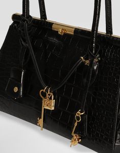 Crocodile-print calfskin Marlene handbag: Black Crocodile-print calfskin handles Gold-plated metal turn-lock fastening Nappa leather lining Item comes with a branded dust bag Measurements: H20.5 x W30 x D12 cm Made in Italy Dolce And Gabbana Purse, Unique Handbags, Handbags Black, Crocodile Print, Bag Measurements, James Bond, Black Handbags, Nappa Leather, Hand Bag