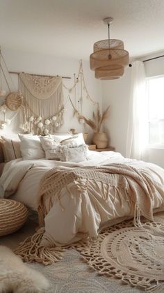 a large bed sitting in a bedroom next to a window with lots of pillows on top of it