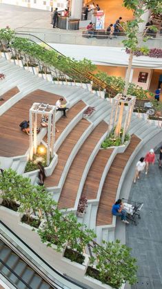 an overhead view of people sitting and walking on the escalators