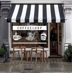 a coffee shop with awnings and tables outside