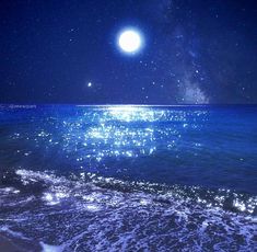 the moon shines brightly in the night sky over the ocean