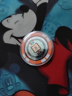 a mickey mouse coin sitting on top of a table