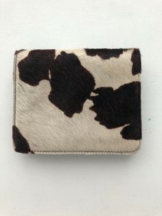 Black And White Pony Hair Cowhide Leather Belt Bag with magnetic closure Never used. Perfect condition. Attaches to any belt. Super stylish. Paid $175.00 Designer Square Wallets For Everyday, Designer Square Wallets, Leather Square Wallet For Everyday Use, Square Leather Wallet For Everyday Use, Tan Leather Wallet, Rectangular, Beige Leather Bag With Card Slots, Tan Leather Rectangular Wallet, Casual Leather Wallet As Gift, Designer Handmade Brown Shoulder Bag