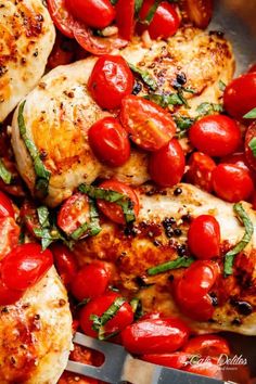 chicken with tomatoes and basil in a skillet ready to be cooked on the grill