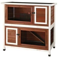 a large wooden and white rabbit hutch with two doors on the front, one door open