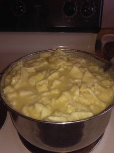 a pot filled with food sitting on top of a stove