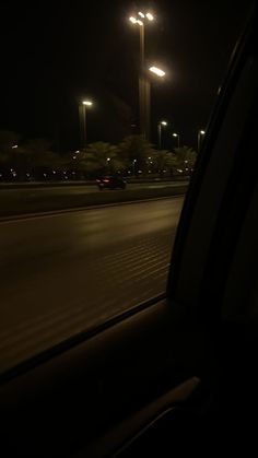 a car driving down the road at night