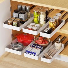 an organized kitchen drawer with spices, utensils and other items on the shelves