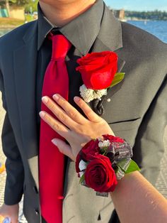 Hoco Corsage For Black Dress, Black And Red Prom Flowers, Black Prom Dress Red Accessories, Prom Coursage Ideas Black And Red, Black Prom Dresses With Red Heels, Black And Red Prom Aesthetic, Red Prom Tux Guys, Red Prom Dress With Black Heels, Tux With Red Dress Prom