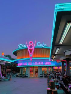 the outside of a restaurant with neon lights