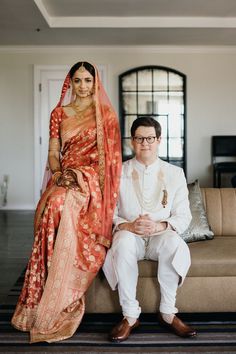 a man and woman sitting on top of a couch