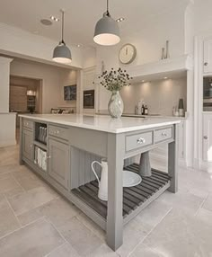 a large kitchen with an island in the middle and lots of counter space on each side