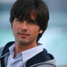 a close up of a person wearing a hoodie and looking at the camera with a serious look on his face