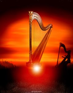 a golden harp sitting on top of a field next to a red and orange sky