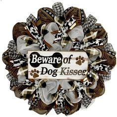 a dog's paw print wreath with the words beware of dog kisseser on it