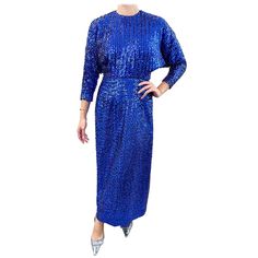 Beautiful 1970s royal blue fully sequined gown ! Features thousands of hand-sewn sequins throughout. Peek-a-boo back with hidden zipper and hook-and-eye closures. Rhinestone buttons at each sleeve cuff. Dolman sleeves can accommodate an array of bust sizes. A true show stopper that is great for any formal attire. In great condition Approximately Size Small Measurements: Up to 44 inch bust (dolman sleeves) 26 inch waist 42 inch hips 55 inches from top back shoulder seam to hem Sequined Gown, Evening Gown Dresses, Gown Dress, Peek A Boo, Dress For Sale, Formal Attire, Dolman Sleeve, Evening Gown, Vintage 70s