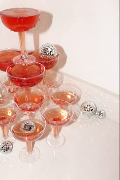 many wine glasses are stacked on top of each other with one glass in the middle