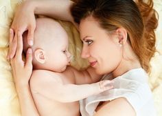 a woman holding a baby in her arms