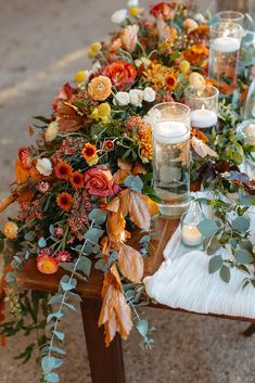 a long table with candles and flowers on it