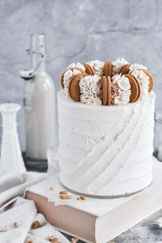 a cake with white frosting and cookies on top