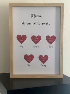 a wooden frame with hearts and names on it