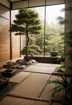 a bonsai tree is in the middle of a room with large windows and graveled flooring