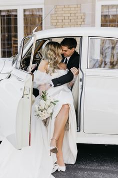 the bride and groom are getting out of the limo together in their wedding attire,