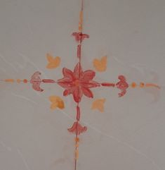 the cross is painted with orange and pink flowers