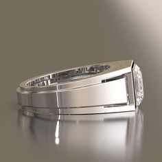 a wedding band with a diamond in the center on a shiny surface, ready to be used as a ring