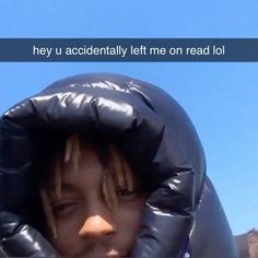 a young man with dreadlocks covering his face in a black plastic bag that says hey u accidentally left me on read lol