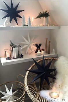 the shelves are decorated with christmas decorations and candles in white, black and grey colors