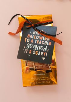 a halloween treat bag with a sign on it that says, ha halloween to a teacher so good it's scary