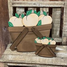 a wooden basket filled with apples sitting on top of a chair