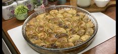 a glass dish filled with food sitting on top of a counter