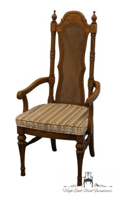 a wooden chair with a striped seat pad on the back and armrests,