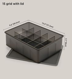 an image of a plastic container with dividers on the top and bottom, measurements for each compartment