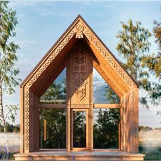 a wooden structure sitting on top of a lush green field