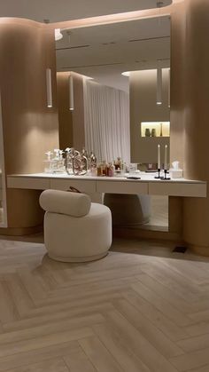 a room with a chair, counter and mirror in it's center area is shown